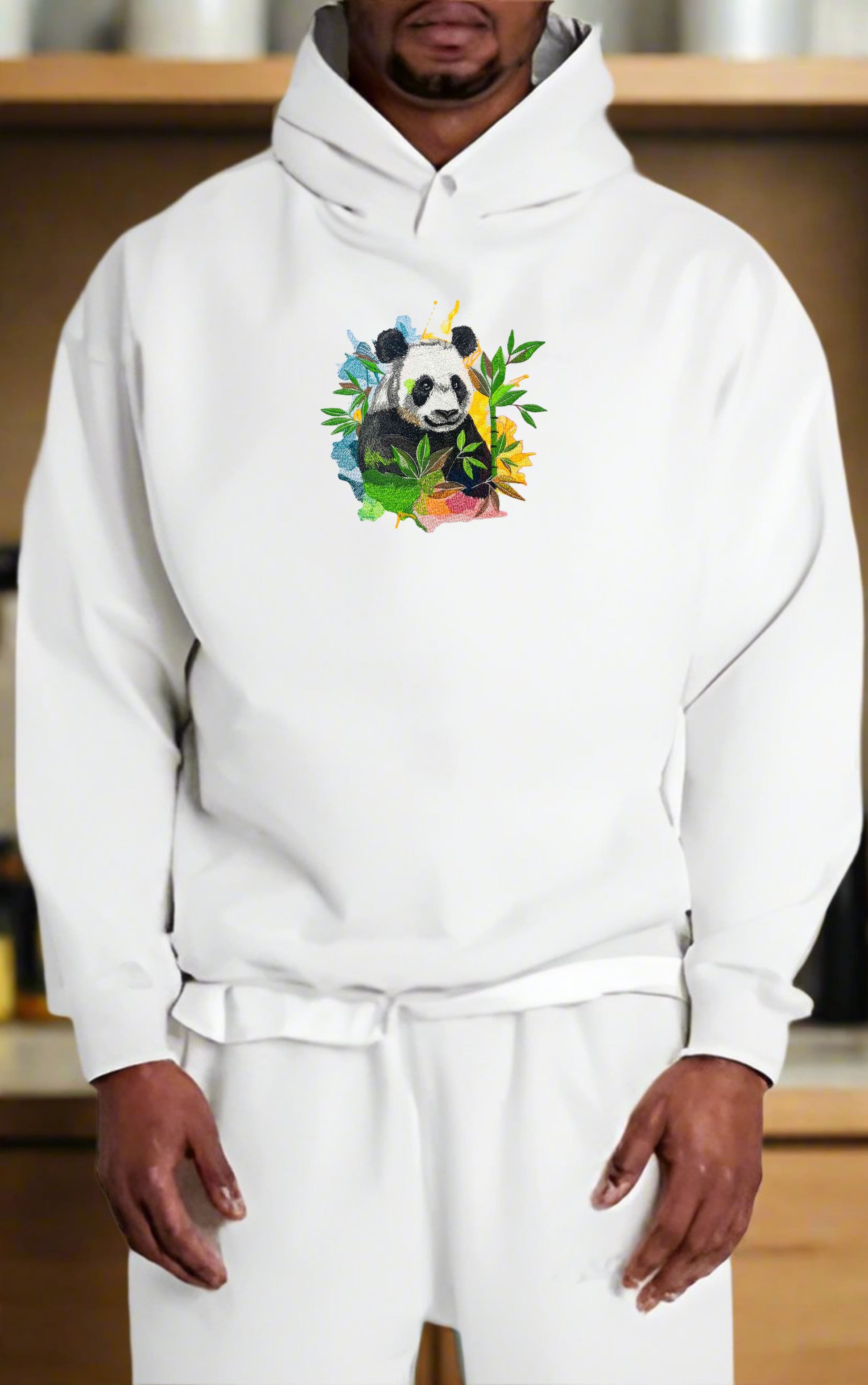 Person wearing a white hoodie with a colorful panda design.