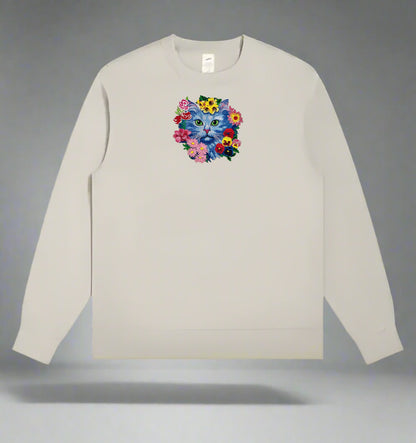 Beige long-sleeve sweatshirt with a colorful cat and flower design on a gray background