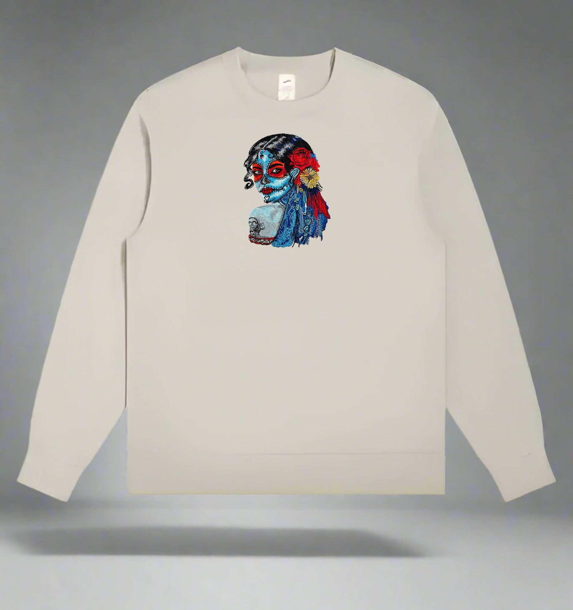 Mint Green  long-sleeve sweatshirt with a  Daydream Muse Sugar Skull Embroidery on a gray background