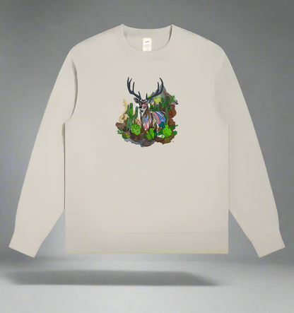 Embroidered crewneck sweatshirt with a design of a mountain deer among snow-dusted peaks and desert cacti.