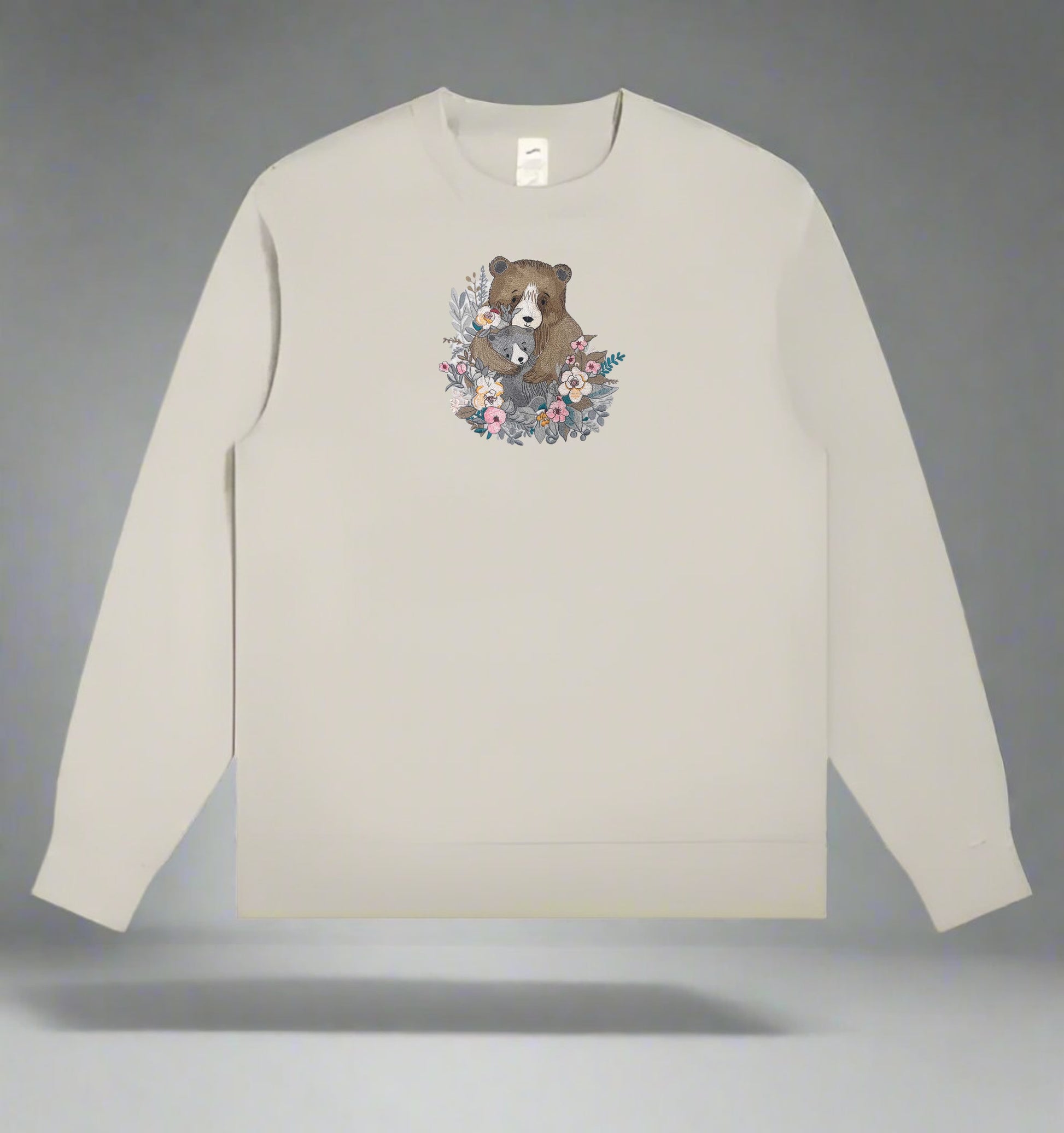 Mint green  long-sleeve sweatshirt with a bear and floral design on a gray background