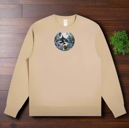 Beige sweatshirt with a circular design featuring an Orca Coral Circle Embroidery – Ocean Dream on a wooden surface.