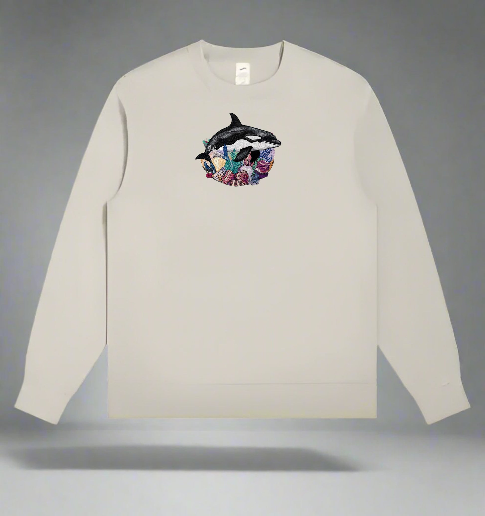 Mint green  long-sleeve sweatshirt with a Orca Reef Garden Embroidery – Ocean Spirit of dolphins on a gray background