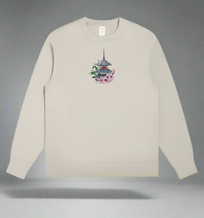 Mint green long-sleeve shirt with a small graphic on a gray background