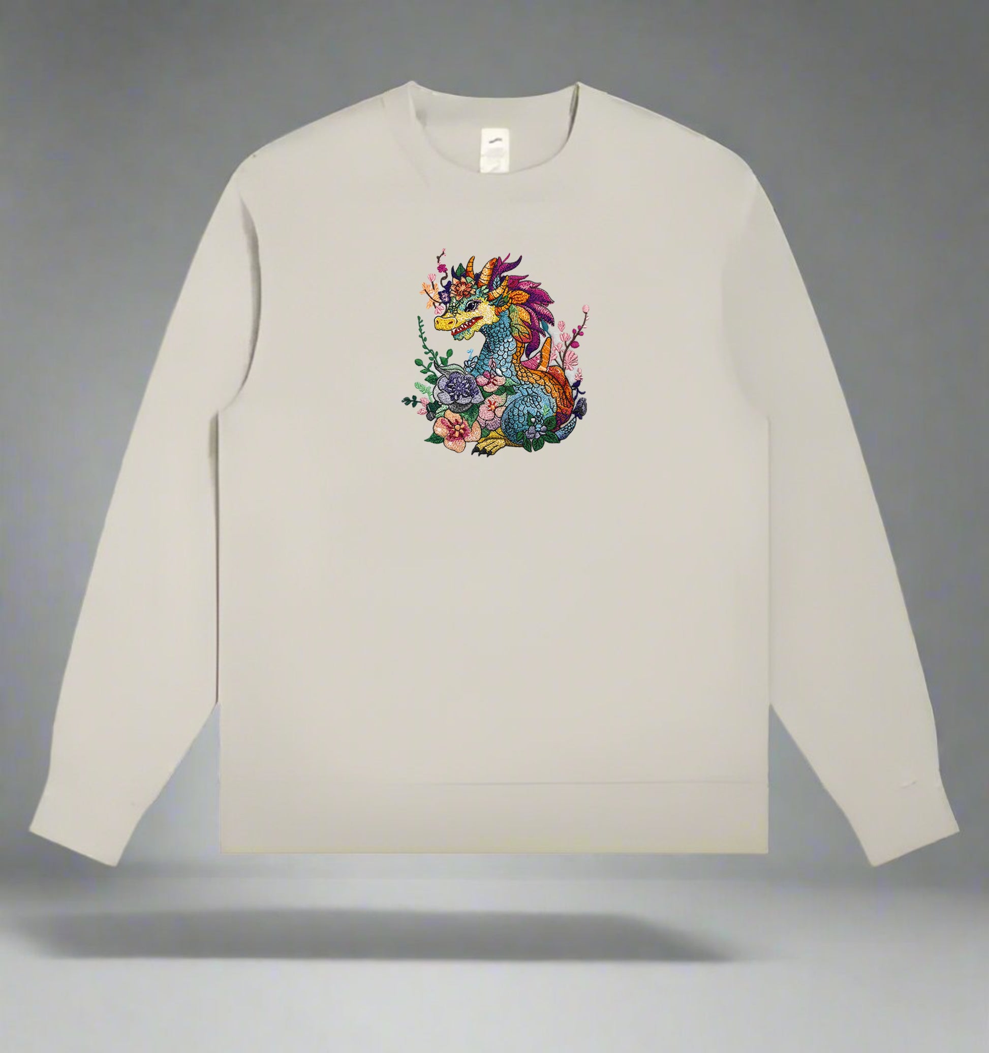 A colorful embroidery design of a dragon with floral elements and a detailed mane and tail.