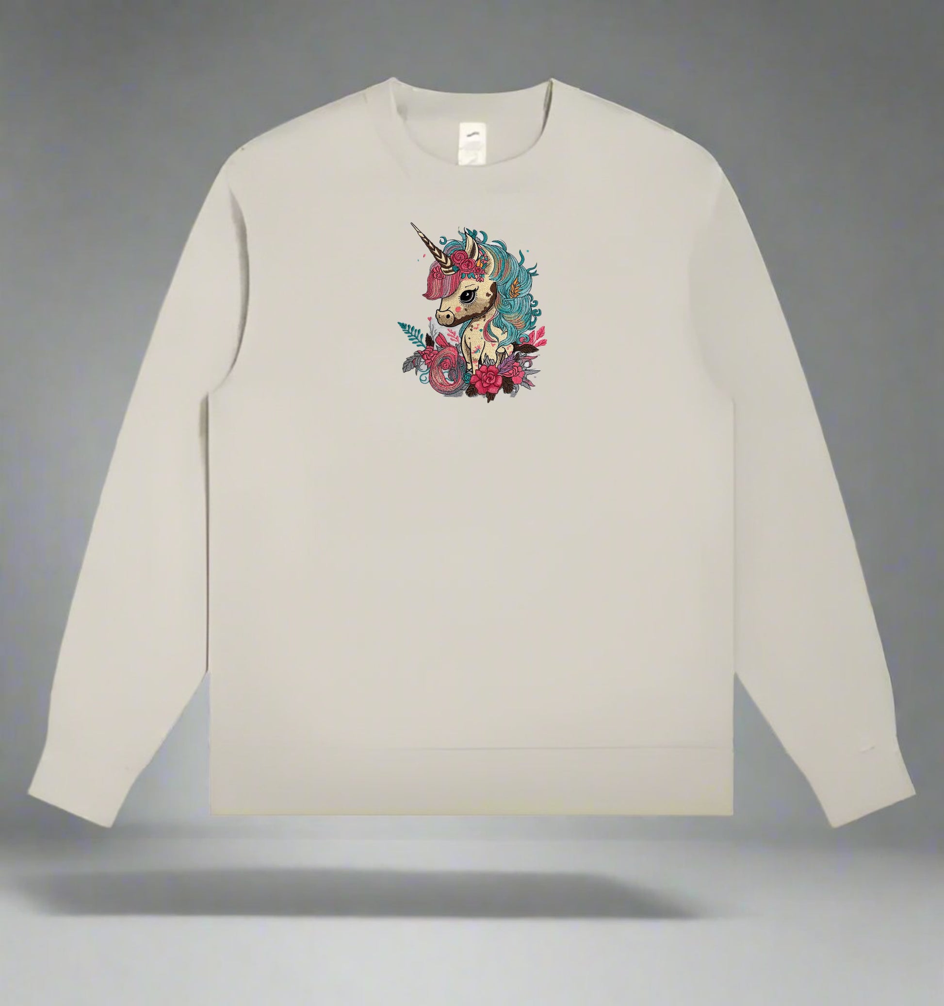 Mint green long-sleeve sweatshirt with a  Whimsical Unicorn Floral Embroidery – Magical Dreams on a gray background
