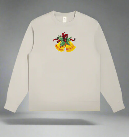 Light beige crewneck sweatshirt featuring embroidered golden Christmas bells with green holly leaves and a red ribbon centered on the chest.