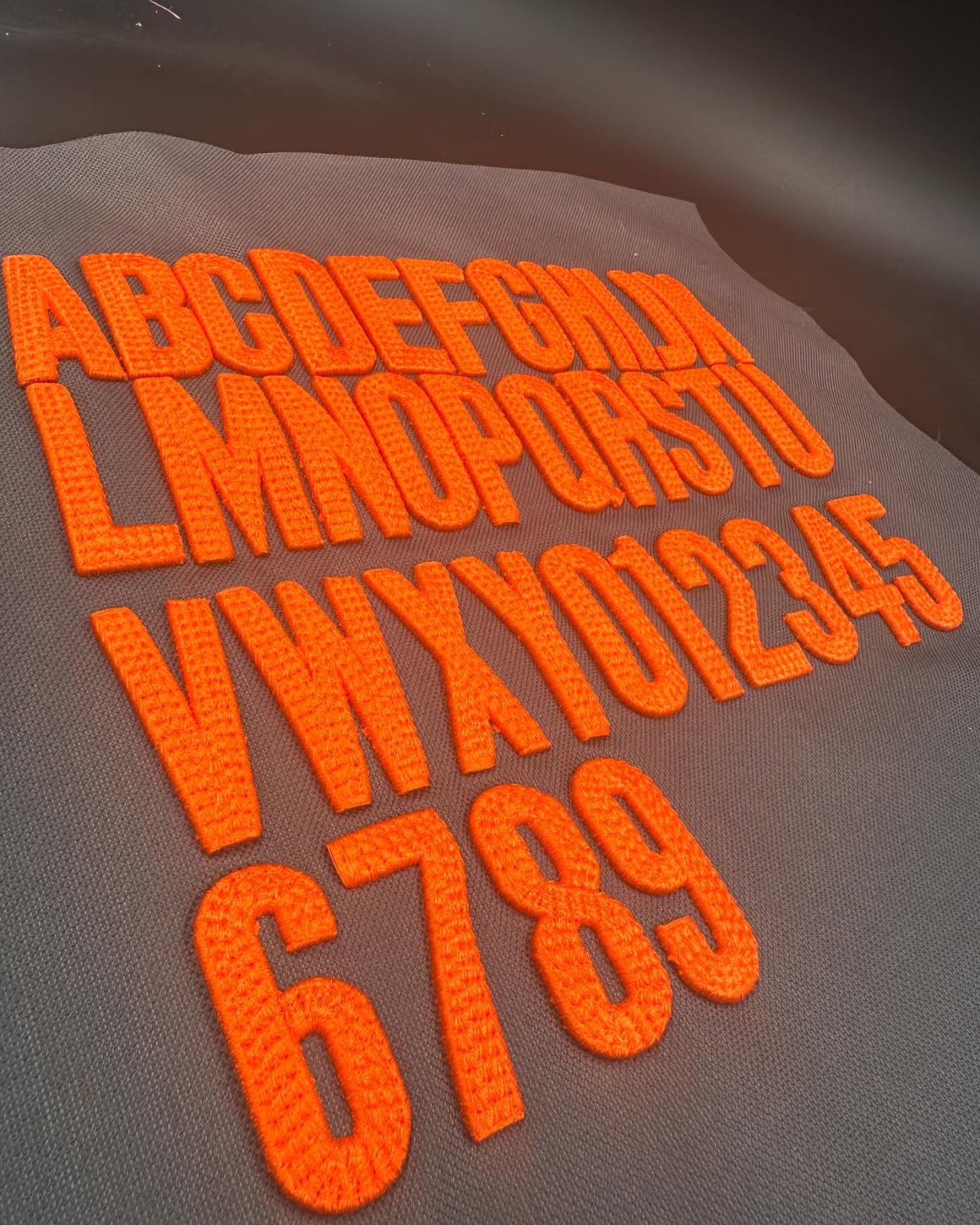 Set of orange letters and numbers on a gray background