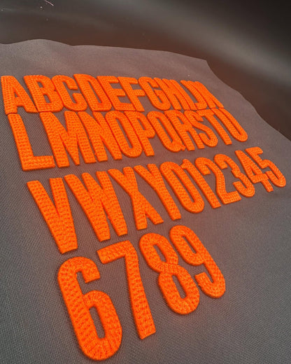 Set of orange letters and numbers on a gray background