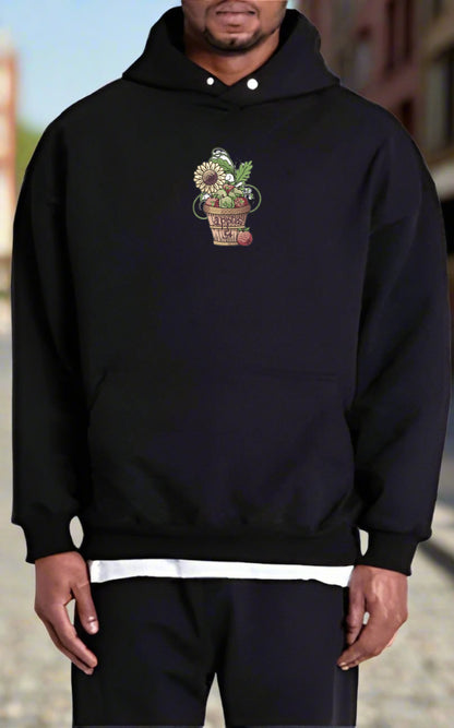 Person wearing a black hoodie with a floral design on a blurred background
