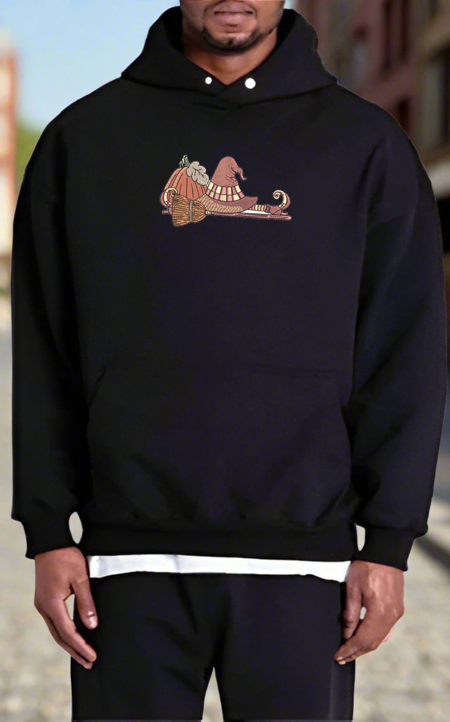 Person wearing a black hoodie with a  If the Broom Fits Ride It Embroidery Design on the chest.