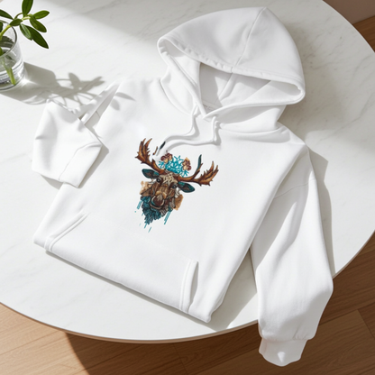 White hoodie mockup featuring an embroidered tribal-style moose head with turquoise accents on the chest, laid flat on a round white table in bright natural light.