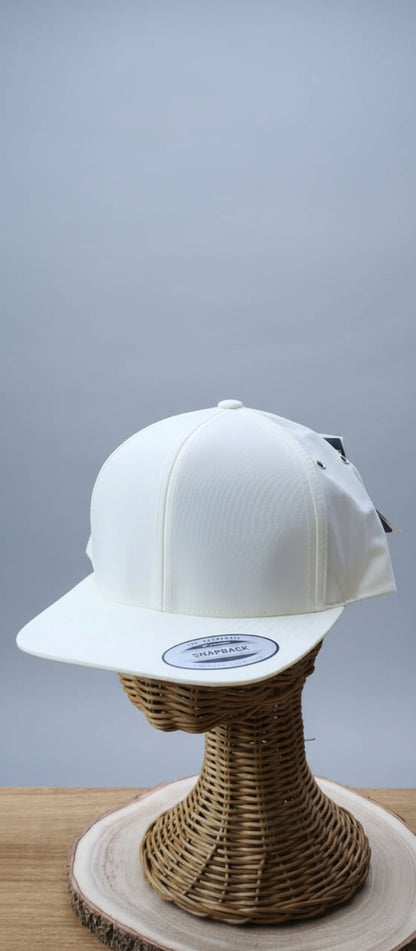 White cap on a wicker stand with a blurred indoor background