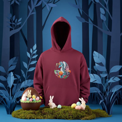 Burgundy hoodie mockup featuring an embroidered blue dragon surrounded by flowers on the chest, styled in a whimsical forest scene with Easter eggs and bunny decorations.