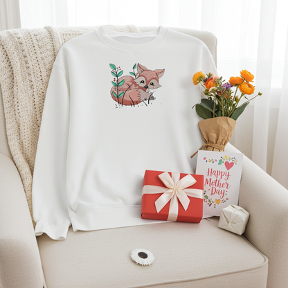 White sweatshirt featuring a cute woodland fox embroidery-style design, styled on an armchair with a bouquet, gift box, and a Mother’s Day card.