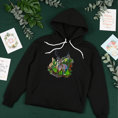 Black hoodie mockup featuring an embroidered deer with antlers and desert cactus landscape on the chest, styled flat lay on a dark green background with leafy branches and greeting cards.