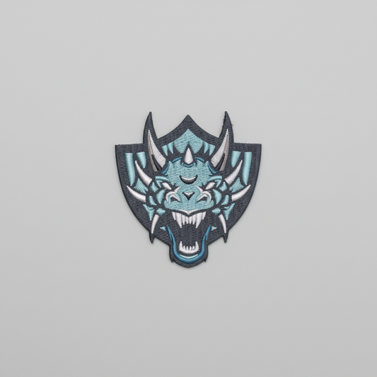 Embroidered dragon design on a grid background