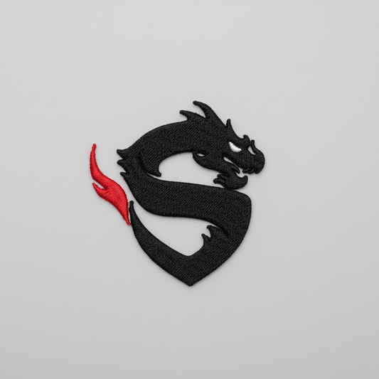 Black dragon design with a red tail on a grid background