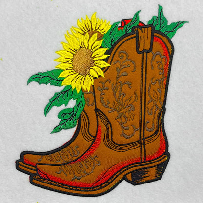 Embroidered patch of a cowboy boot with a sunflower on a white background