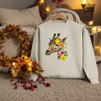Mint green sweatshirt hanging on a wooden hanger in a cozy bedroom setting, featuring a giraffe head embroidery with colorful floral accents, styled with warm string lights, autumn wreath, and decorative berries