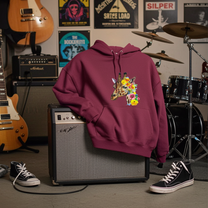 Burgundy hoodie mockup featuring an embroidered giraffe head with colorful wildflowers on the chest, styled in a music studio with guitars, amplifiers, drum kit, band posters, and sneakers on the floor.