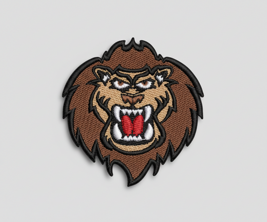 Embroidered patch of a lion's head with a fierce expression on a grid background