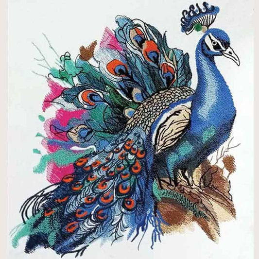 Majestic peacock embroidery design featuring a blue peacock with colorful feather details in teal, orange, and pink, stitched on light fabric with watercolor-style accents.