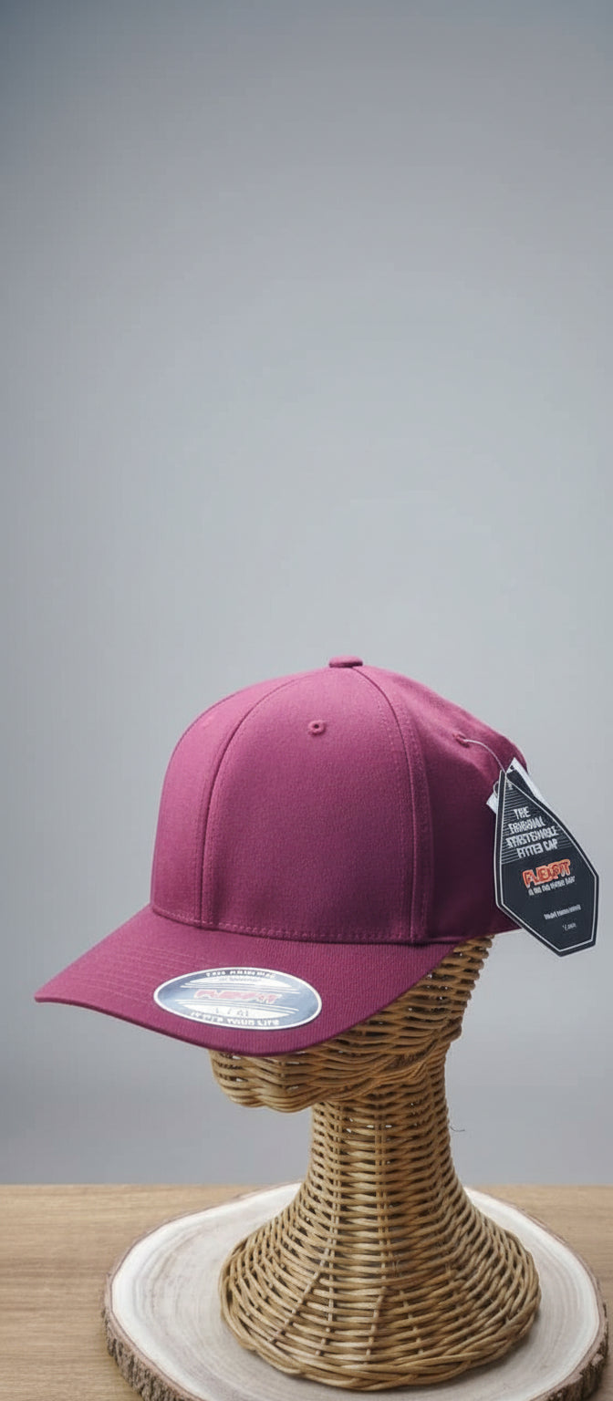 Pink cap on a mannequin head with a brand tag in an indoor setting
