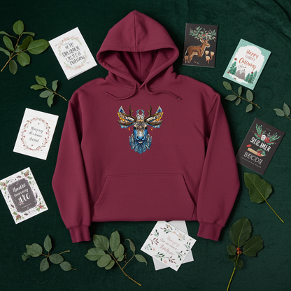 Burgundy premium hoodie with Ornate Moose embroidery featuring intricate blue and gold antlers, flat lay on a dark green background with greenery and holiday greeting cards, original EmbroMania artwork.