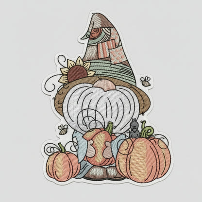 Embroidered design of a gnome with pumpkins and a checkered hat on a white background