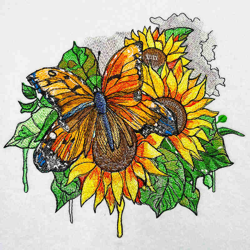 Colorful embroidery design of an orange butterfly over bright yellow sunflowers with green leaves, vibrant nature-inspired artwork, original EmbroMania design.