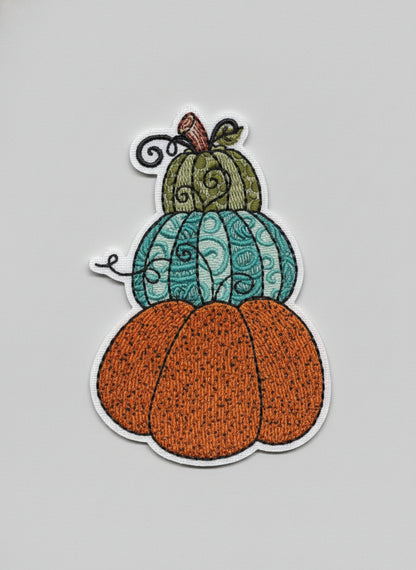 Three stacked pumpkins with textured surface on a white background