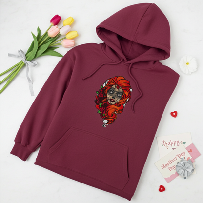 Burgundy premium hoodie with Sugar Skull Rose Girl embroidery featuring a sugar skull portrait with bright orange hair and red roses, styled with tulips, Mother’s Day cards, and small heart accents, original EmbroMania artwork.