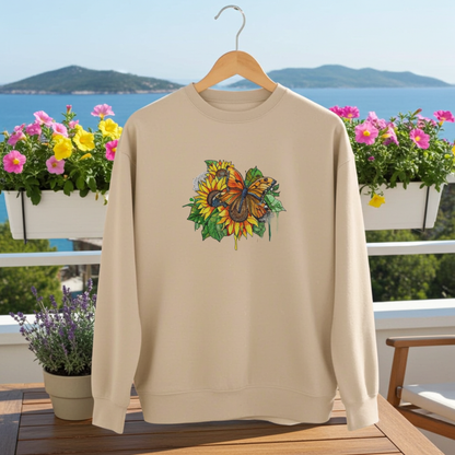 
Beige unisex crewneck sweatshirt with sunflower and butterfly embroidery design, styled on balcony chair with ocean view and flower boxes.
