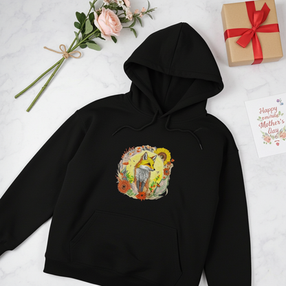 Black premium hoodie with Sunshine Fox & Sunflower embroidery featuring a fox framed by sunflowers and wildflowers in warm tones, styled with roses, a Mother’s Day card, and a wrapped gift, original EmbroMania artwork.