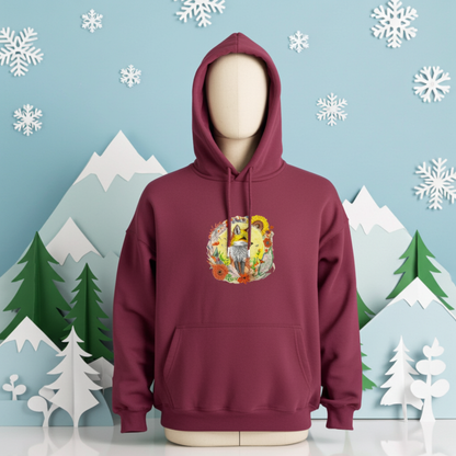 Burgundy premium hoodie with Sunshine Fox & Sunflower embroidery featuring a fox framed by sunflowers and wildflowers in warm tones, styled in a winter scene with snowflakes, mountains, and pine trees, original EmbroMania artwork.