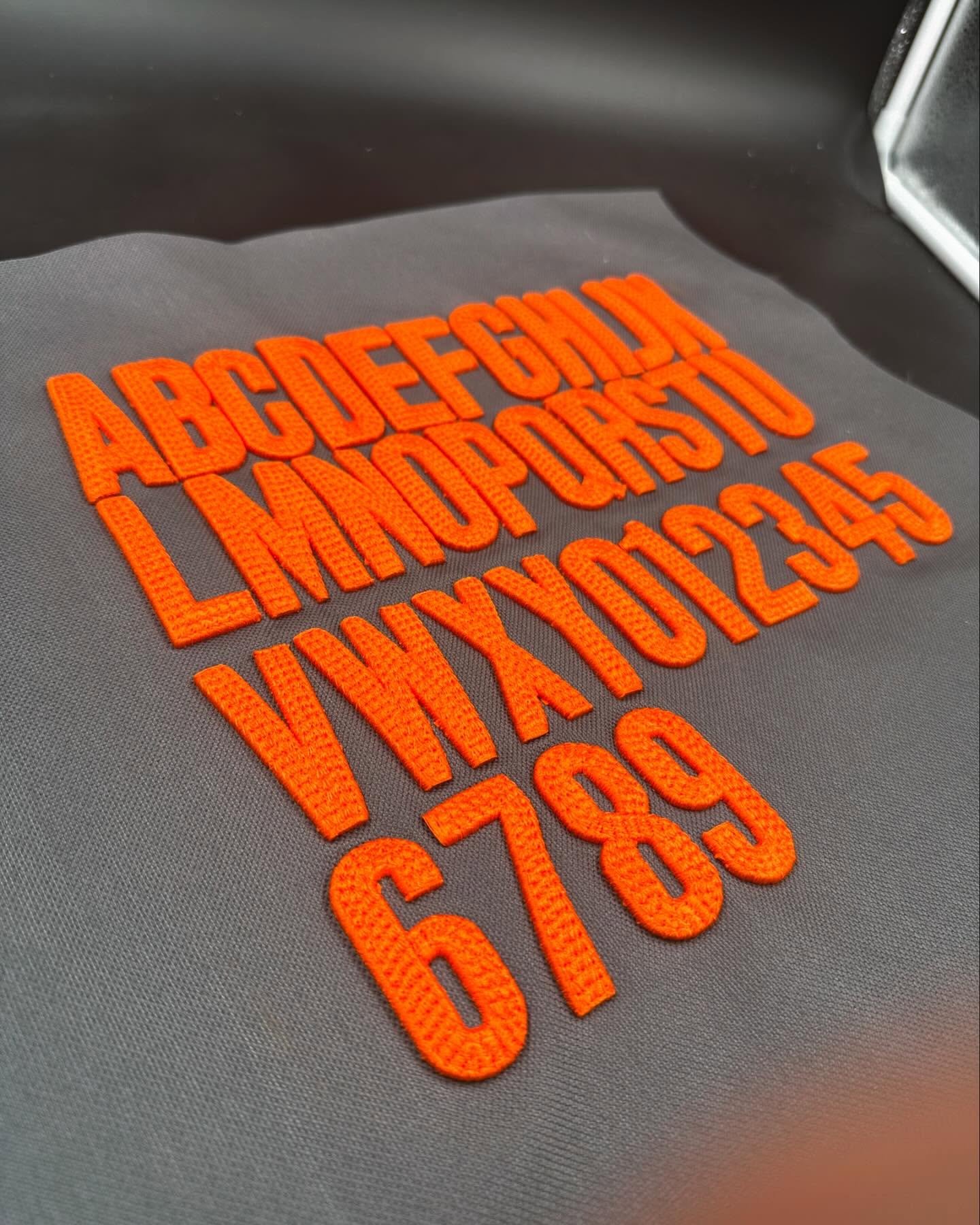 Orange letters and numbers on a gray background