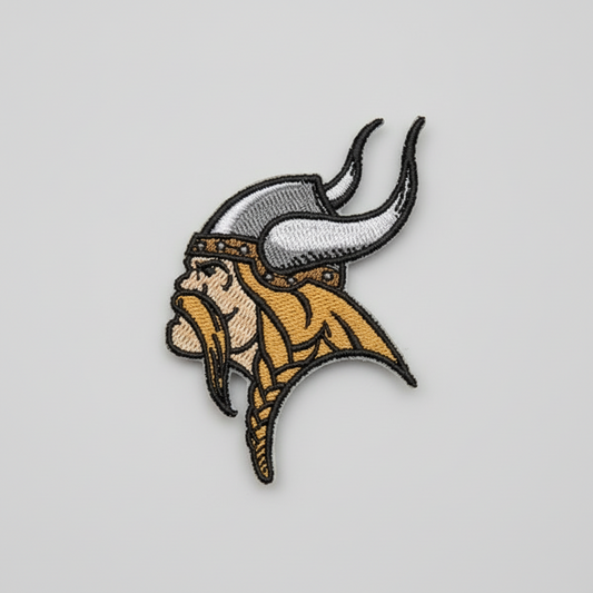 Embroidered design of a viking head with horns on a grid background