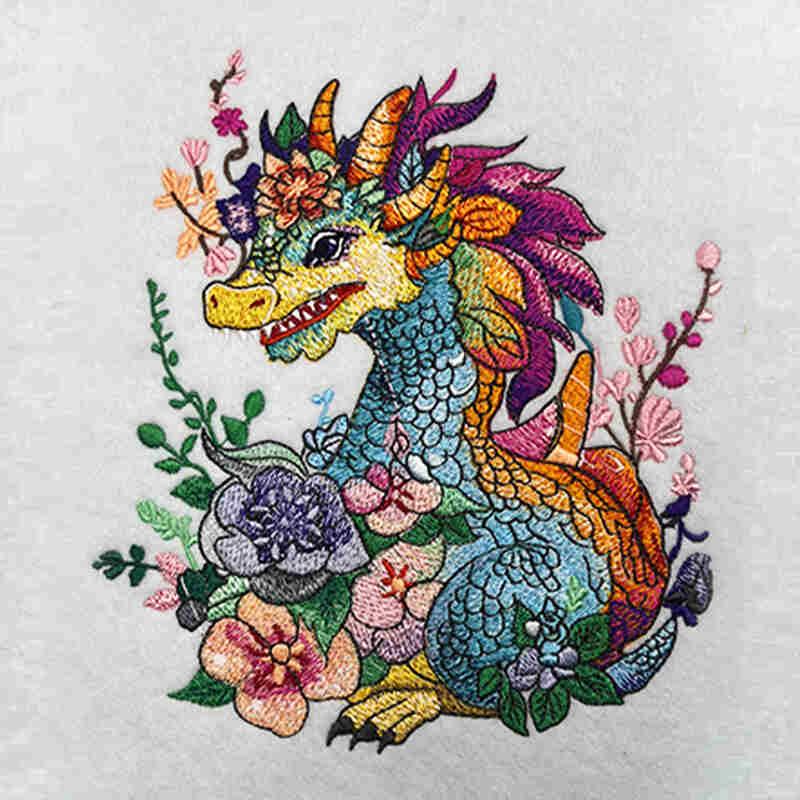 A colorful embroidered sweatshirt featuring a celestial dragon surrounded by cherry blossoms and wild peonies.