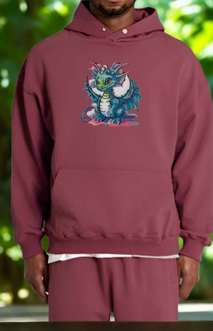 Person wearing a maroon hoodie with a colorful dragon design on a blurred green background