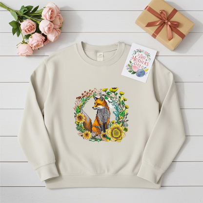 Mint green unisex crewneck sweatshirt with wild sunflower fox embroidery in floral wreath design, flat lay with roses, gift box and Mother’s Day card.