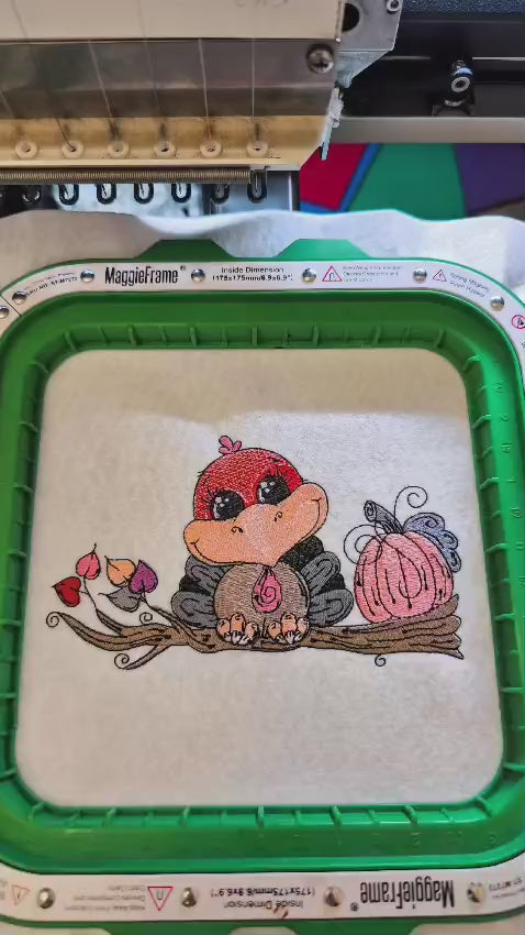 Embroidered Thanksgiving design featuring a cute turkey sitting on a tree branch with autumn leaves and a pumpkin. Perfect for hoodies, sweatshirts, and tote bags.