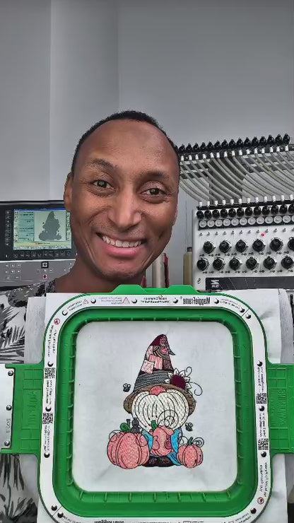 Embroidered fall design featuring a whimsical gnome with a sunflower hat, holding a pumpkin, surrounded by pumpkins and bees. Perfect for hoodies, sweatshirts, and tote bags.