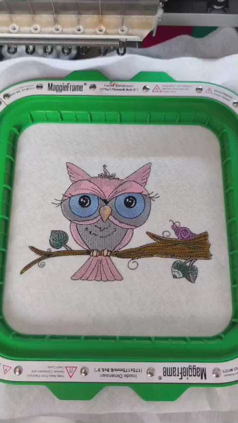 Embroidered design of a cute pink owl with large blue eyes perched on a branch, with a purple snail beside it. Perfect for kids’ hoodies, sweatshirts, and tote bags.