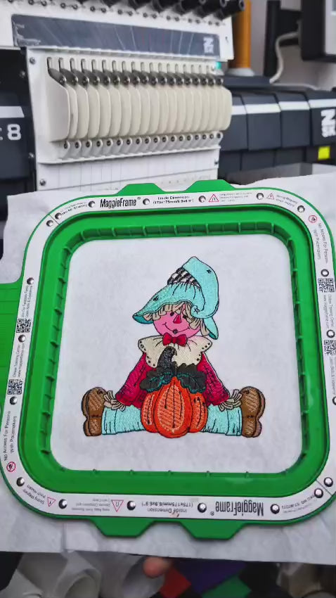 Embroidery machine creating a cute scarecrow autumn design, followed by a view of the studio and ending with the Embromania logo.